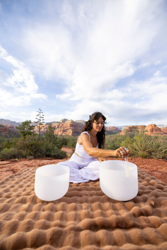 Sound bowls on red rock cliff