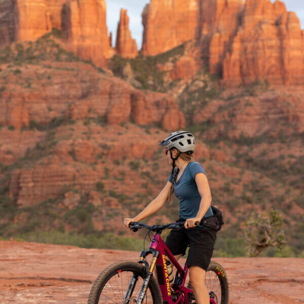 Woman on red mountain bike in front for Cathedral Group