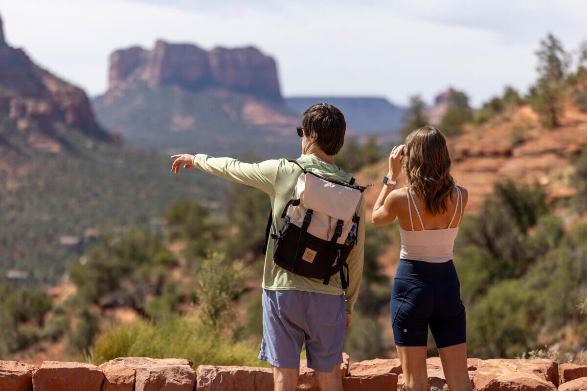 Couple hiking and sightseeing with binoculars in Sedona